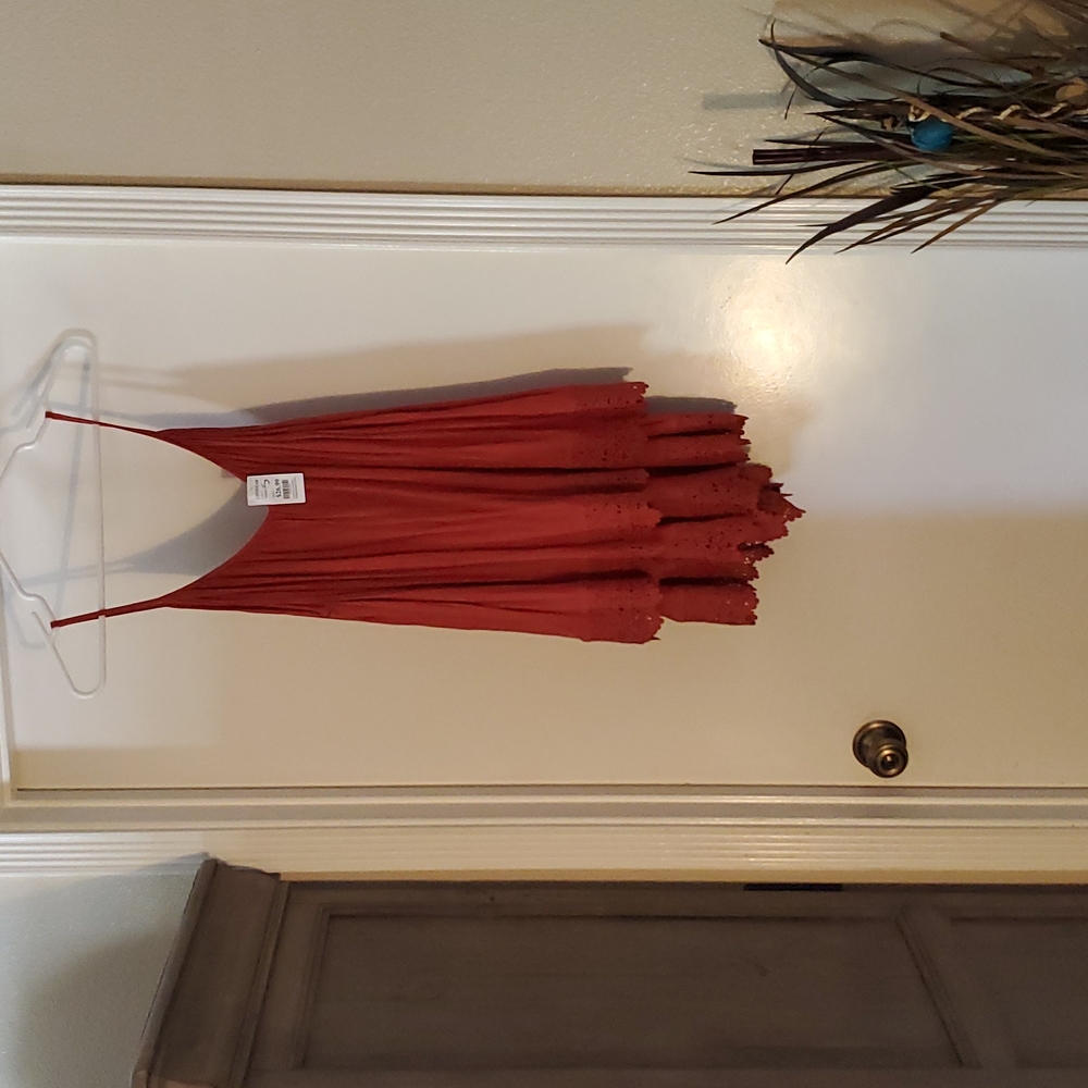 Burnt orange rompers with thick lace trim and button in back.